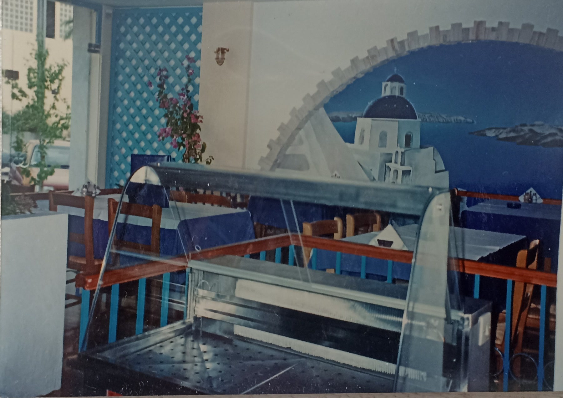 Inside Karnagio in the early years, with blue details and the Santorini mural